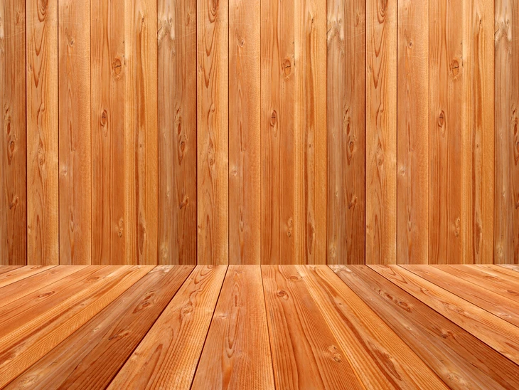 Intérieur vide avec murs et sol en bois naturel créant un espace d'exposition tridimensionnel